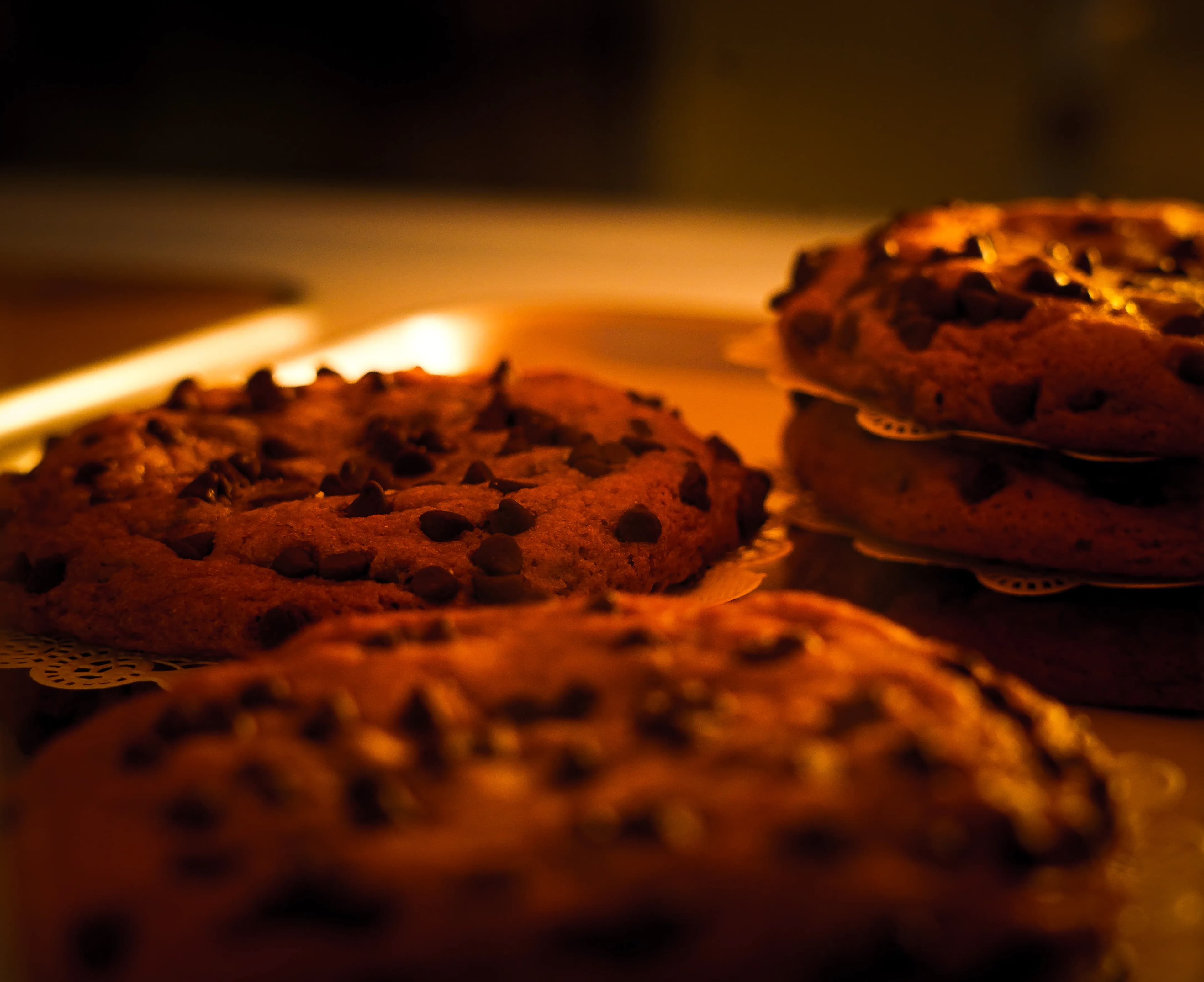 Golden-brown chocolate chip cookies on lace doilies