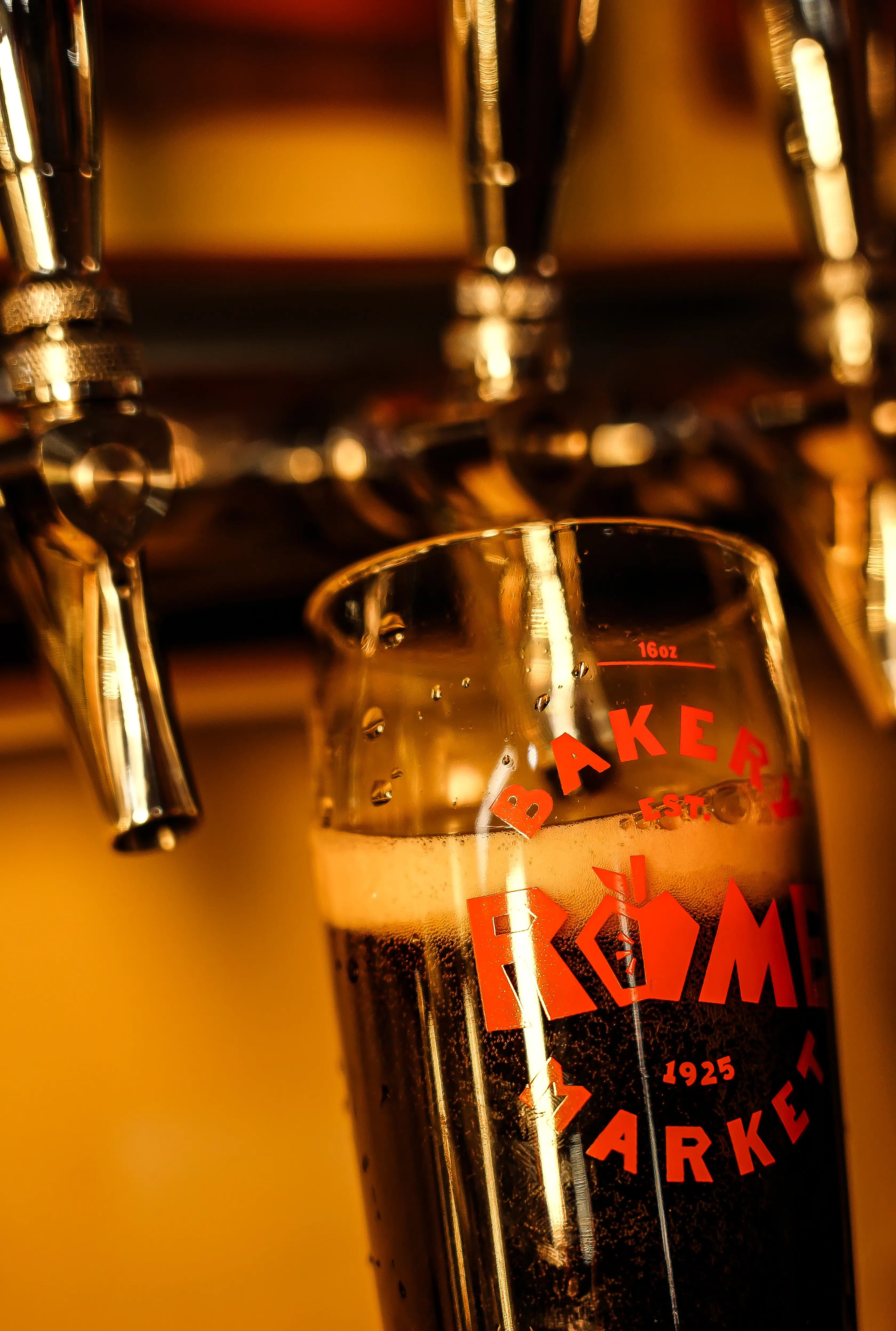 Beer from a tap being poured into a glass.
